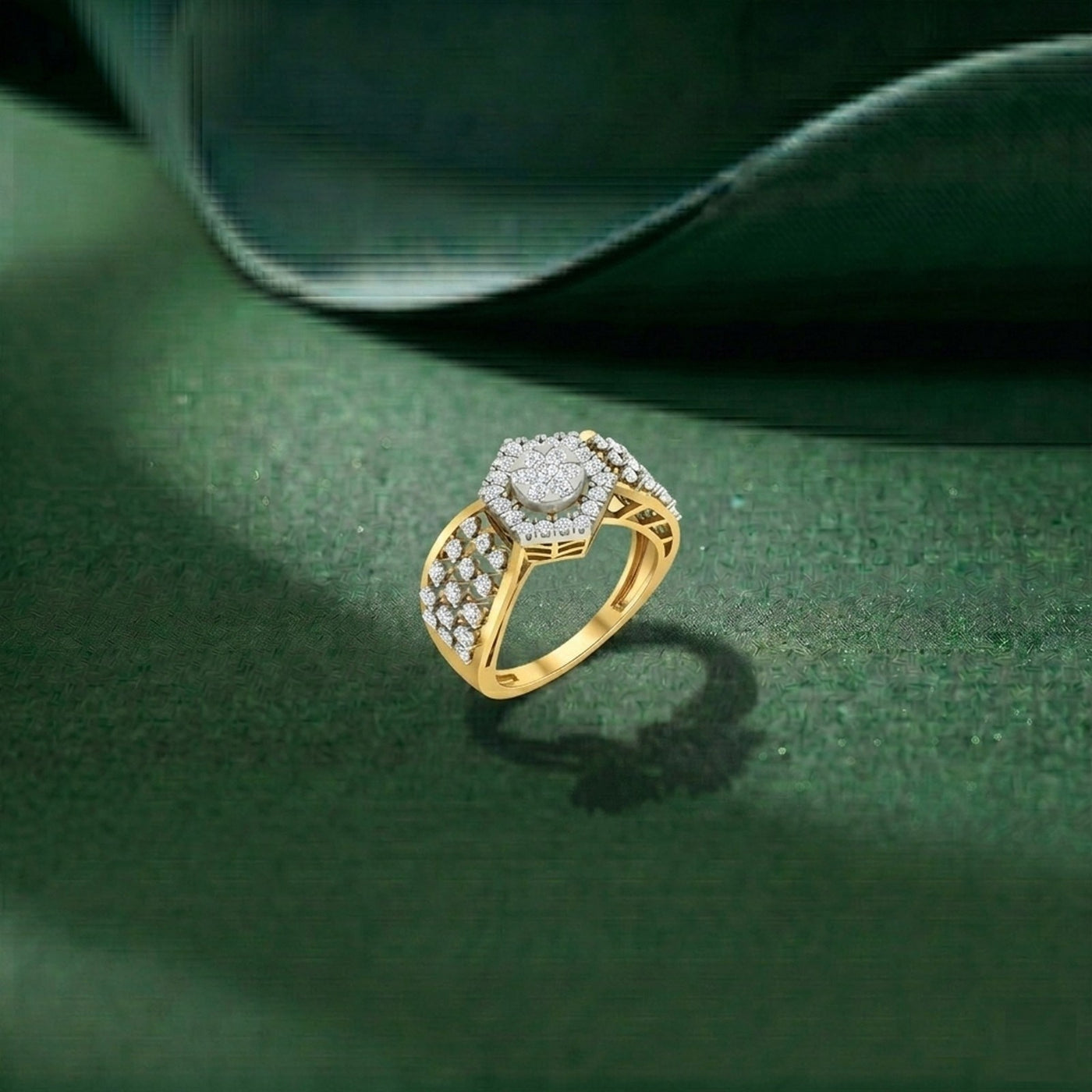 Gold ring with diamonds on a green surface