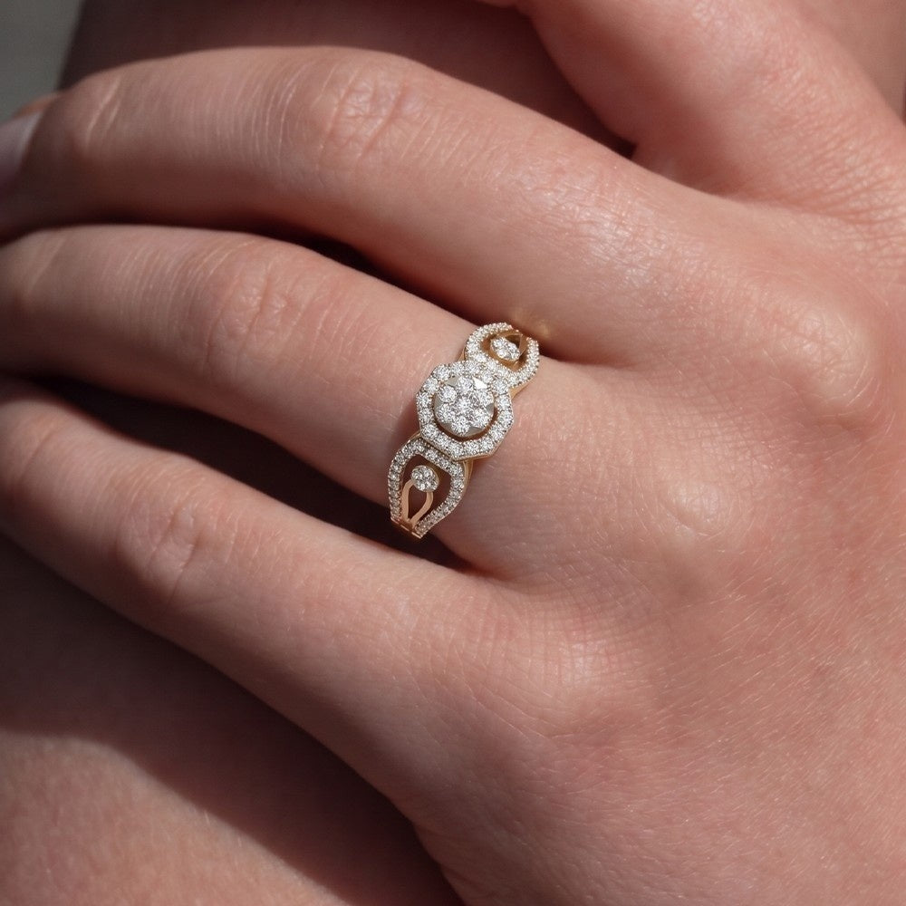 Rose gold ring with diamonds on a person's finger