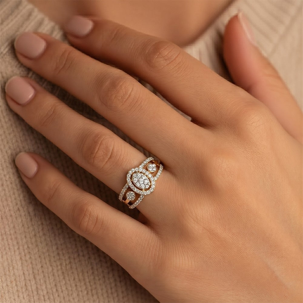 Close-up of a hand wearing a decorative ring on a neutral background.
