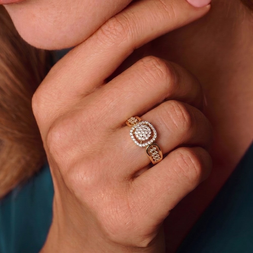 Close-up of a hand wearing a diamond ring with a blurred background