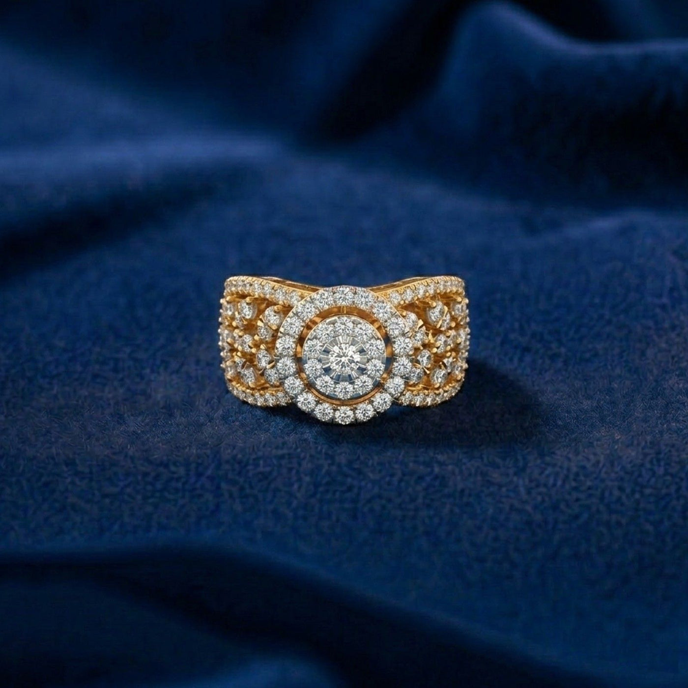 Gold and diamond ring on a blue fabric background