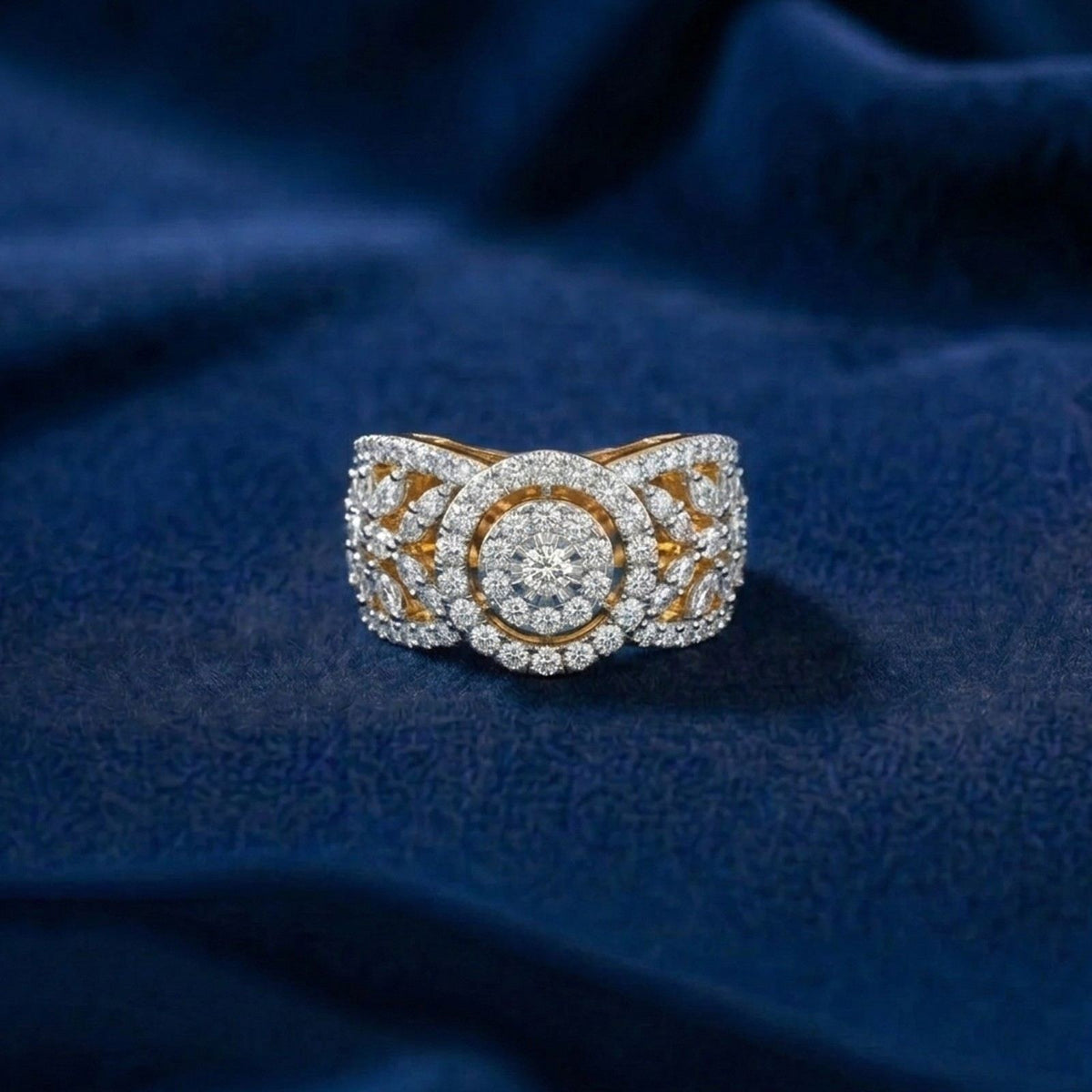 Gold and diamond ring on a blue fabric background