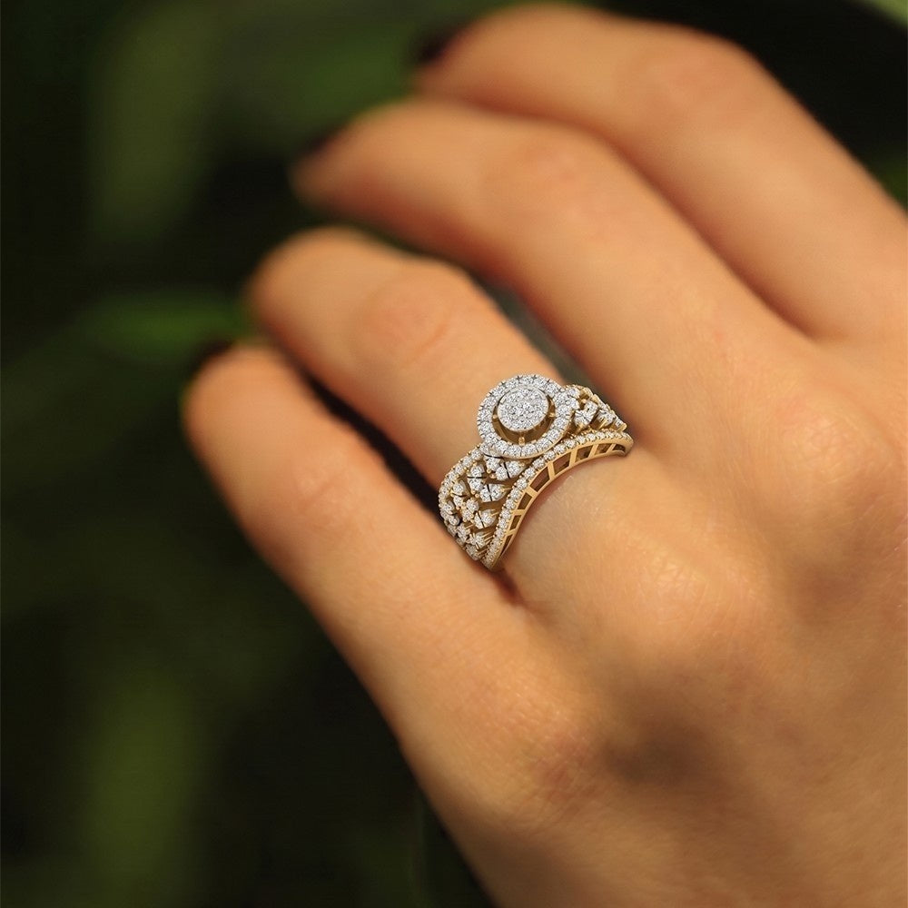 Gold and diamond ring on a person's finger with a blurred green background