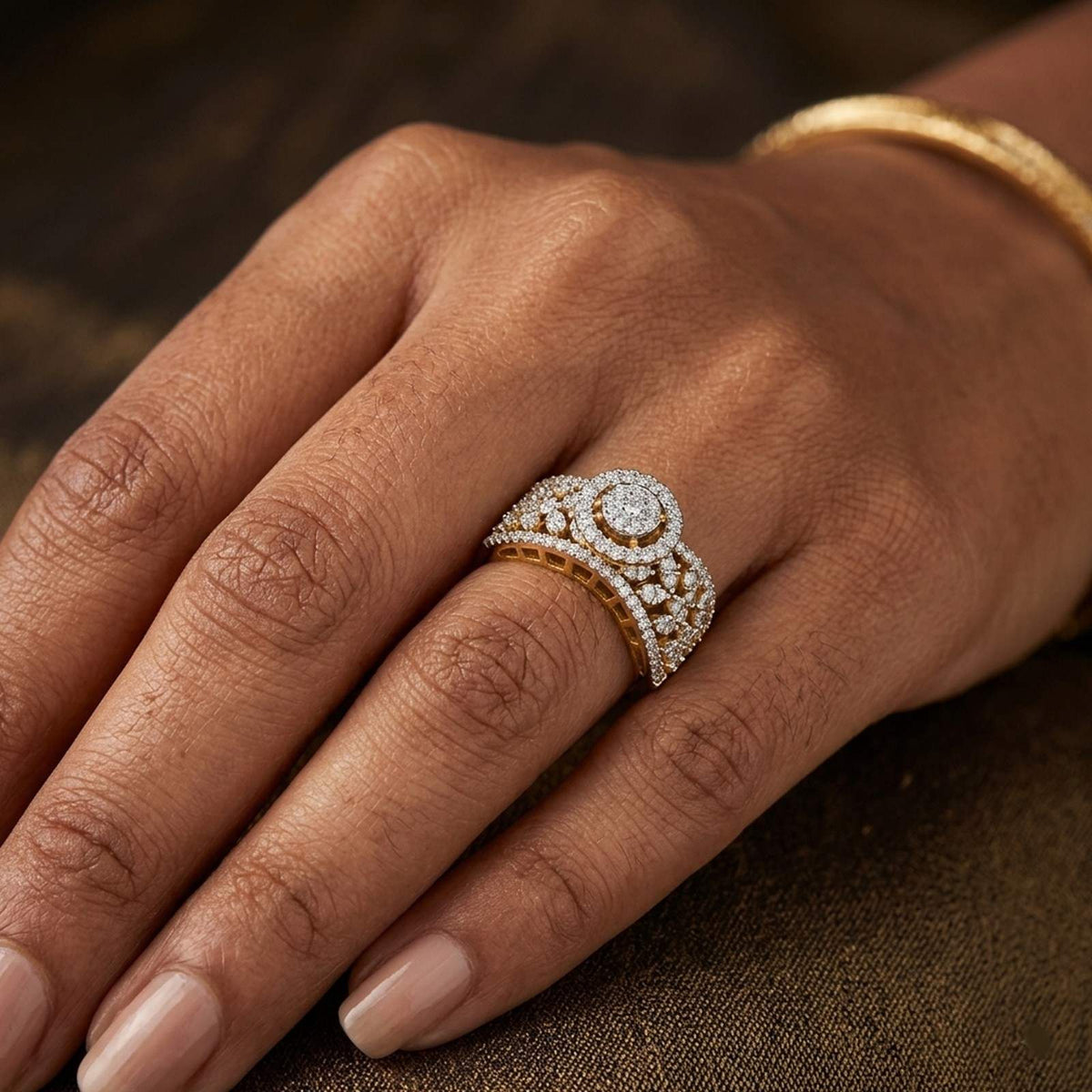 Gold and diamond ring on a person's finger with a blurred green background