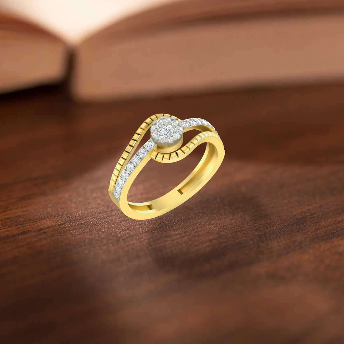 A gold and diamond ring, resting on a dark wooden surface with a blurred book in the background.