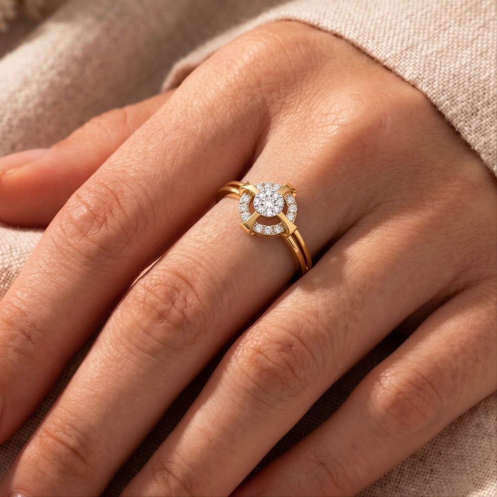 Close-up of a hand wearing a gold ring with a diamond on a neutral background