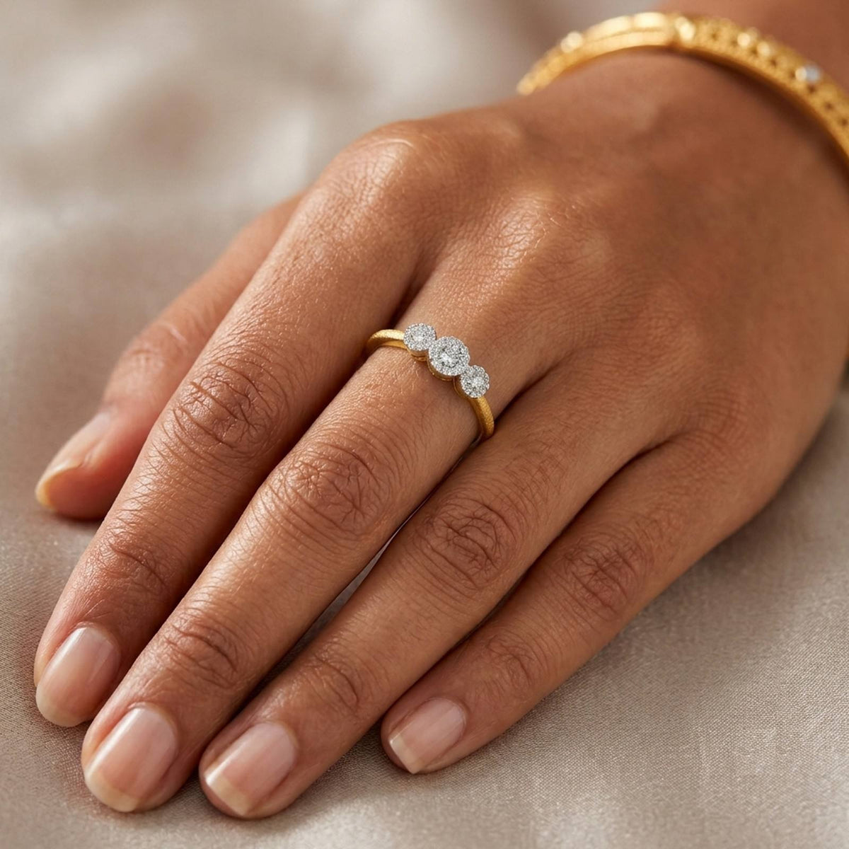 Gold and diamonds ring with three cluster on a hand