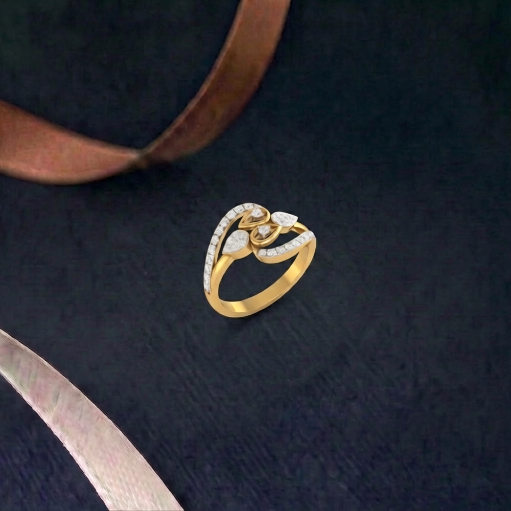 A gold ring with a floral design set with small clear stones, displayed on a dark textured background with decorative ribbons.
