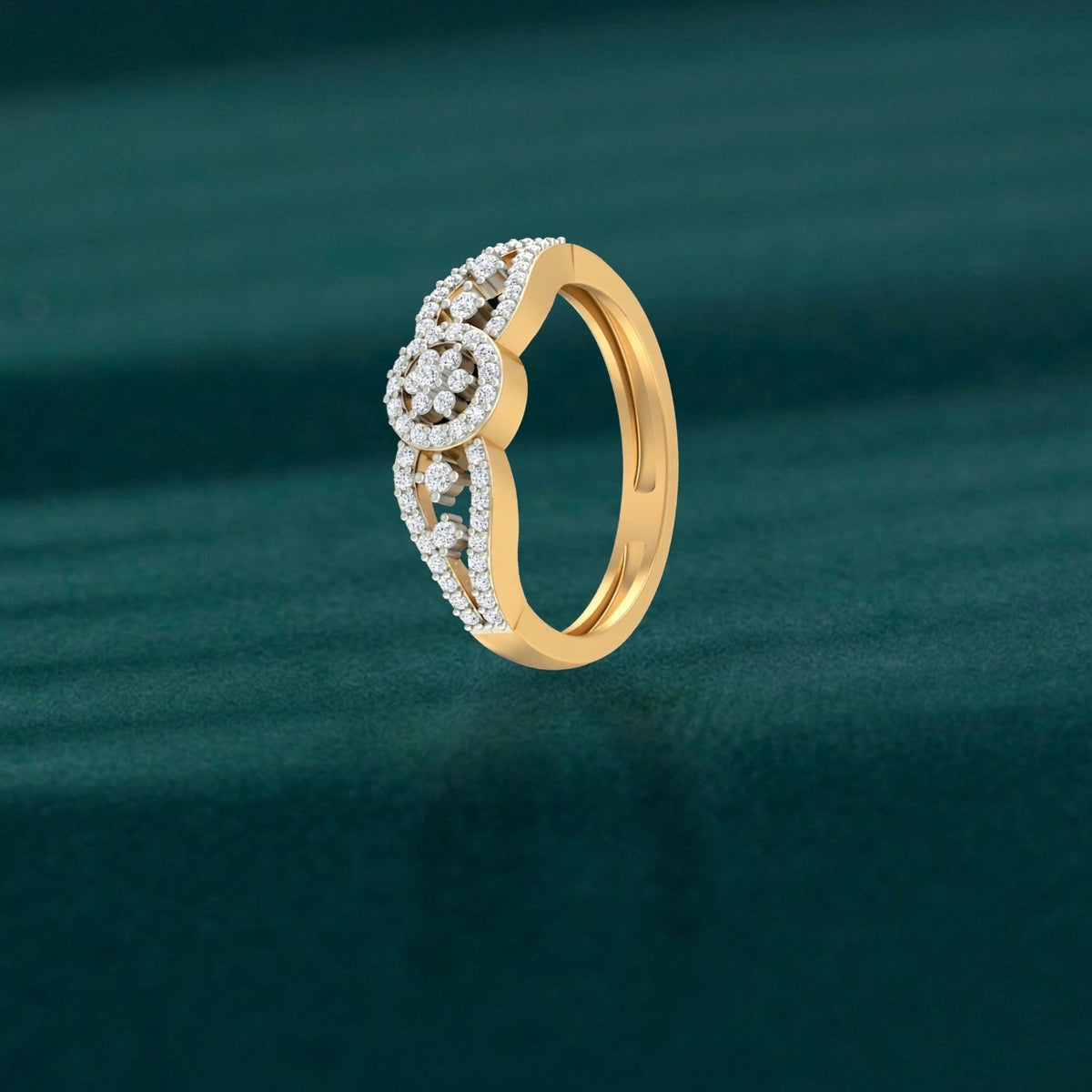 Gold ring with diamond accents on a green textured background.