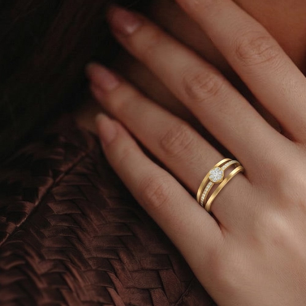A close-up of a hand wearing a gold and diamond ring.