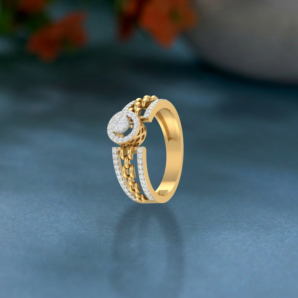 Gold ring with diamond accents on a blue background.
