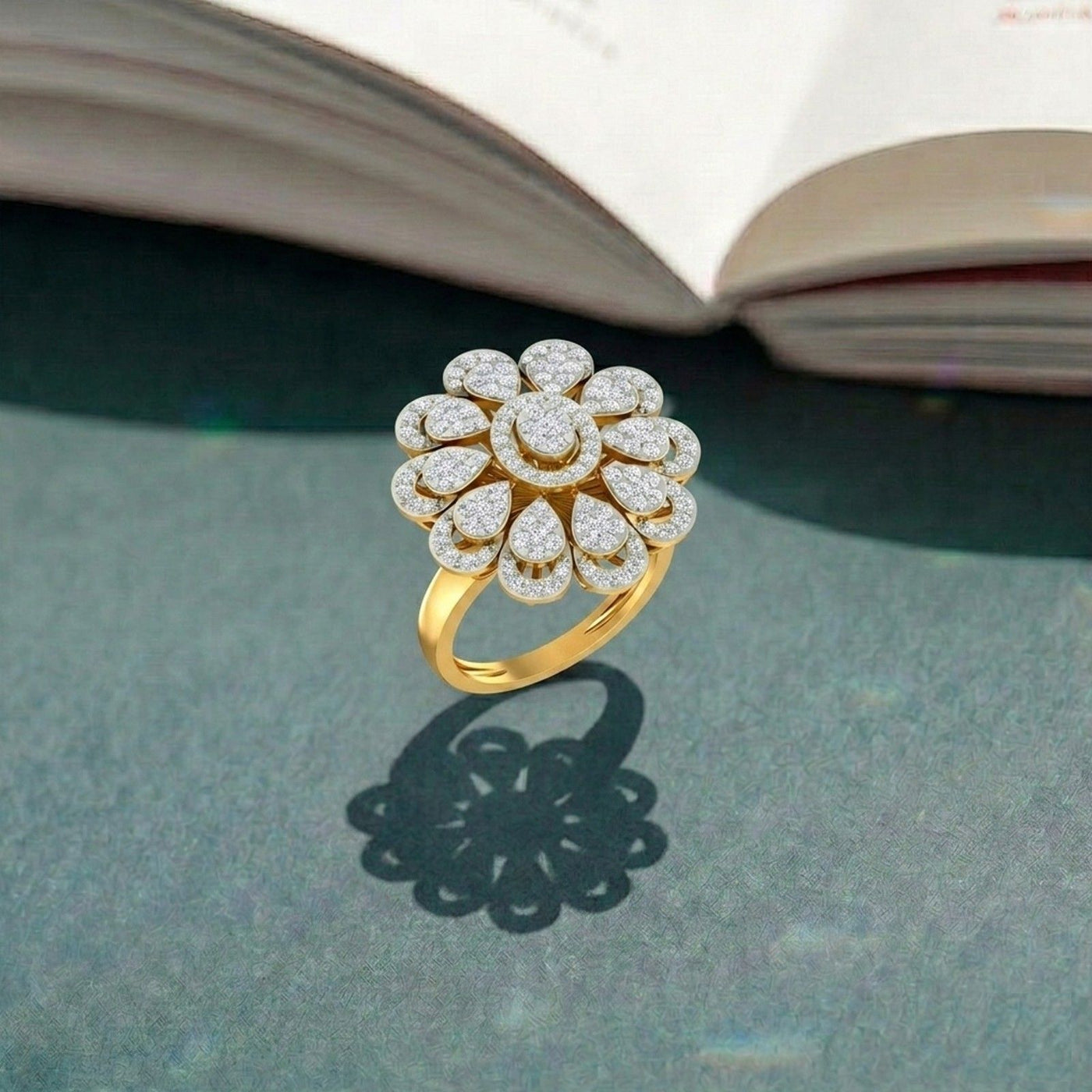 Gold ring with diamonds on a textured surface with an open book in the background