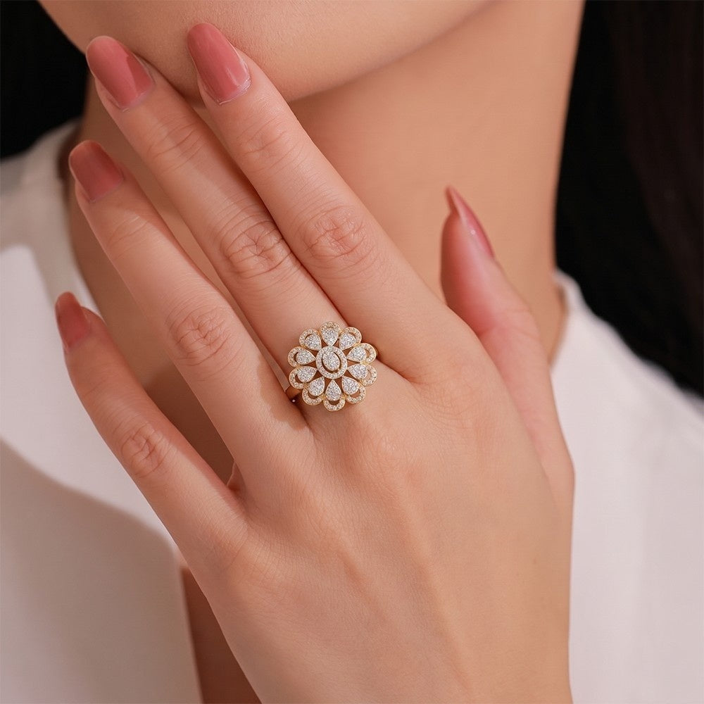 Close-up of a hand wearing a gold and diamond  ring with a blurred background