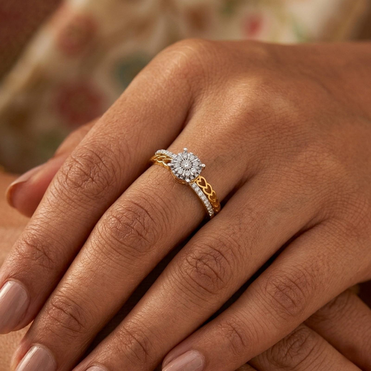 Gold ring with a diamond cluster ring on a person's finger