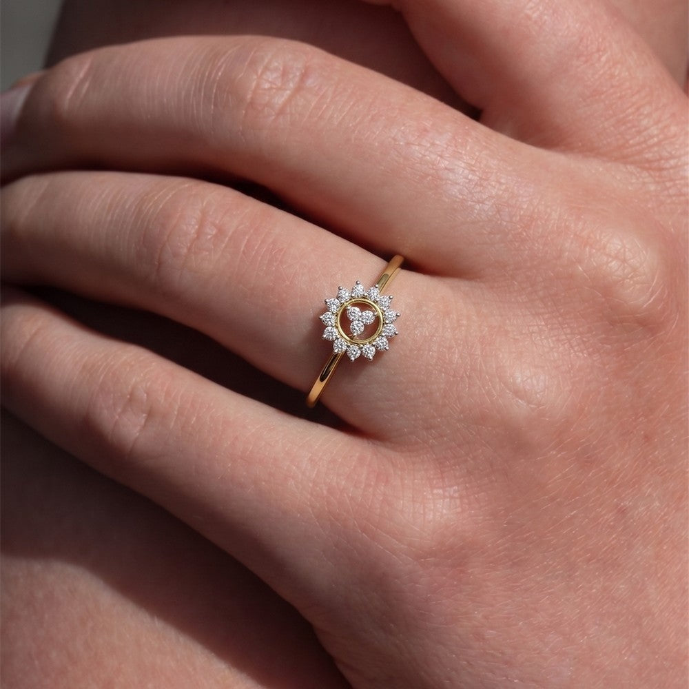 Close-up shot of a gold and diamond with floral design ring.