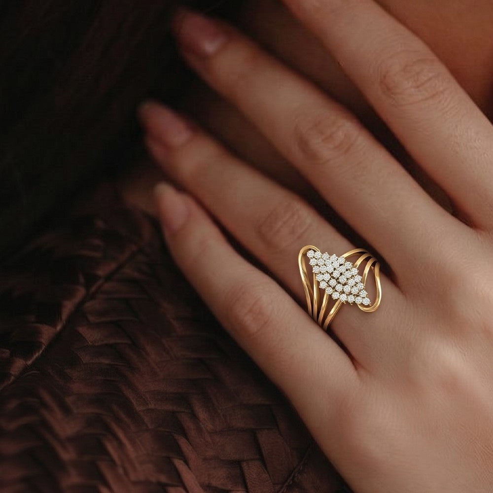 Gold ring with diamonds on a hand against a dark background.