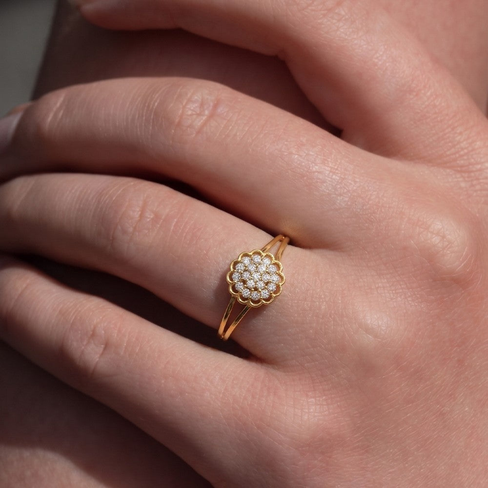 Gold ring with diamonds on a person's finger