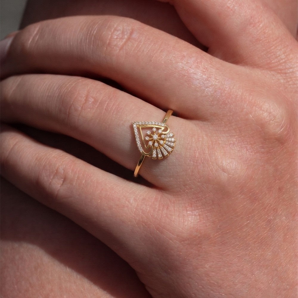 Gold ring with diamond accents on a person's finger