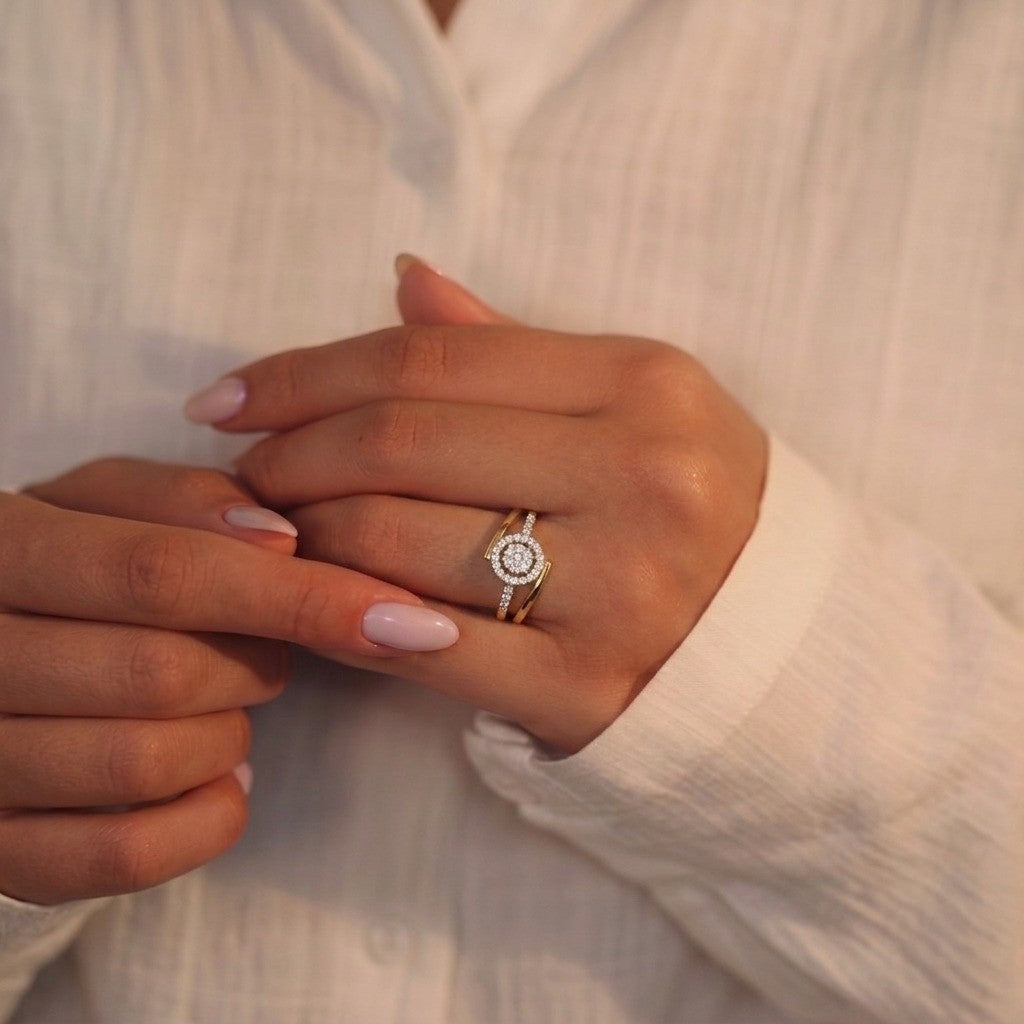 Close-up shot of a gold and diamond with halo cluster setting ring.