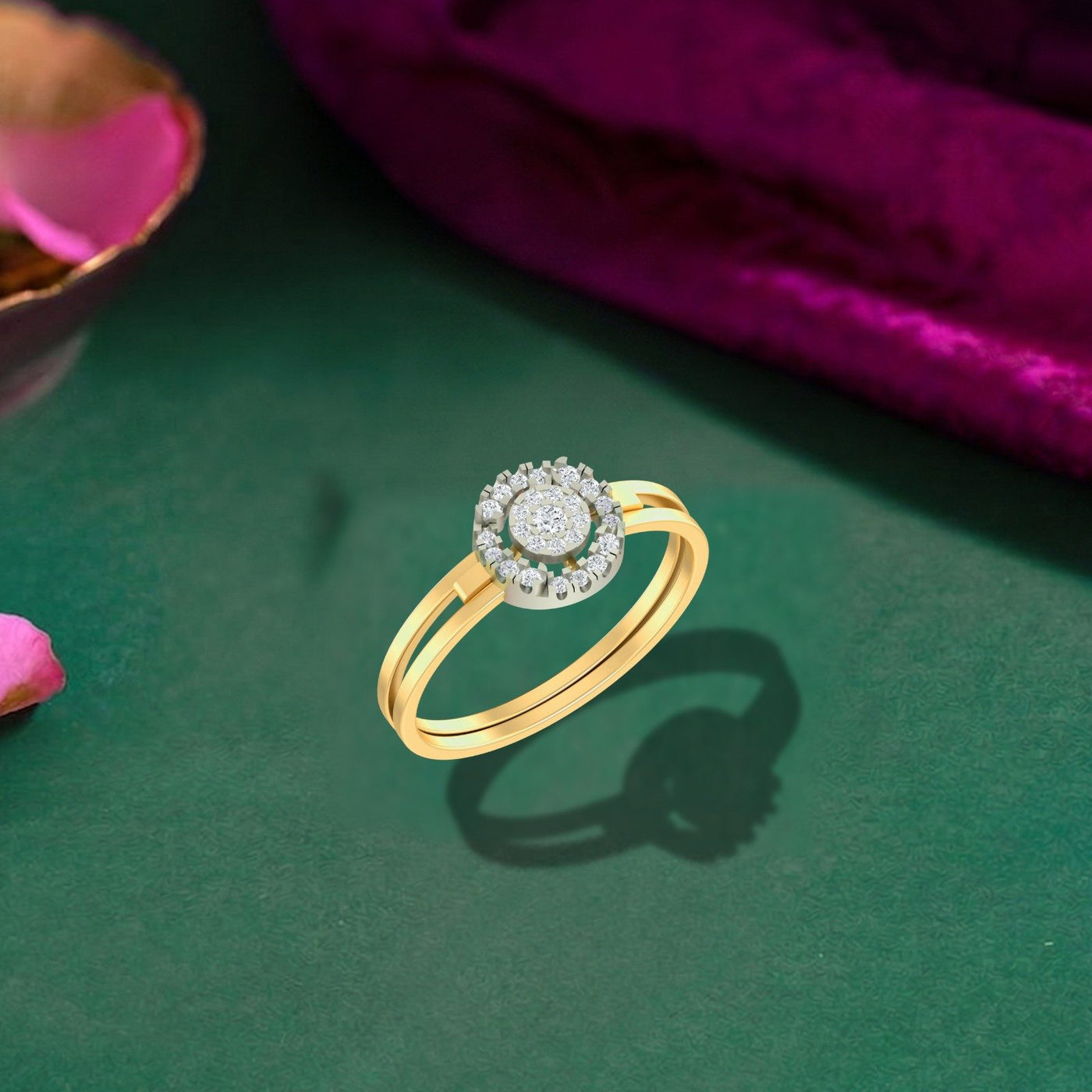 Gold and diamond with halo cluster setting on a green surface.