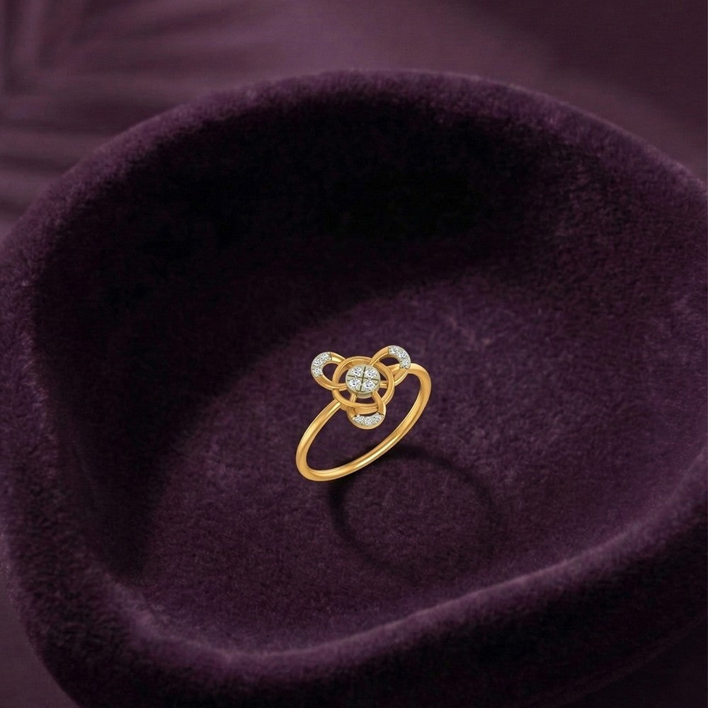 Gold and diamond with circular cluster setting on a fabric surface.