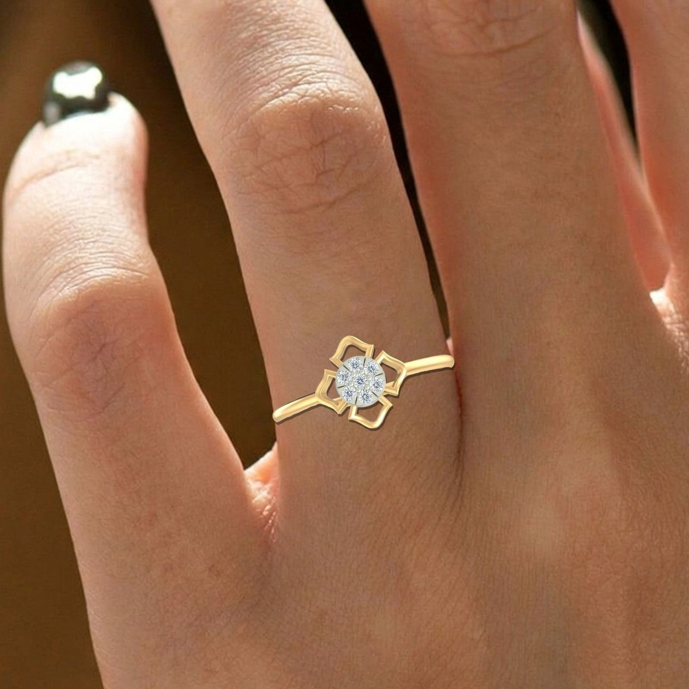 Close-up shot of a gold and diamond with round-shaped cluster setting ring.