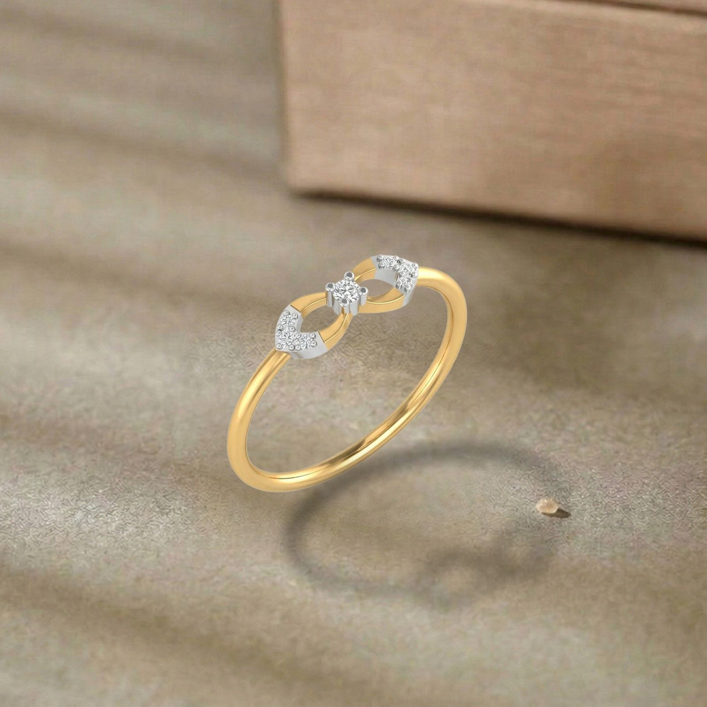 Gold and diamond ring with diamonds on a brown surface.