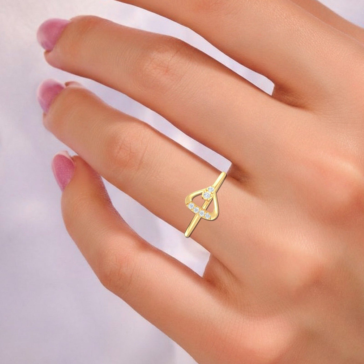 Close-up shot of a gold and diamond women's ring.