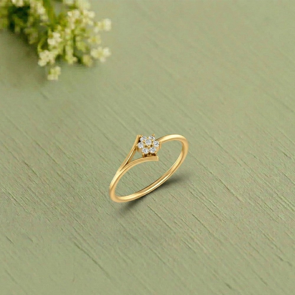 Gold and diamond with floral-design cluster setting on a green texture surface.