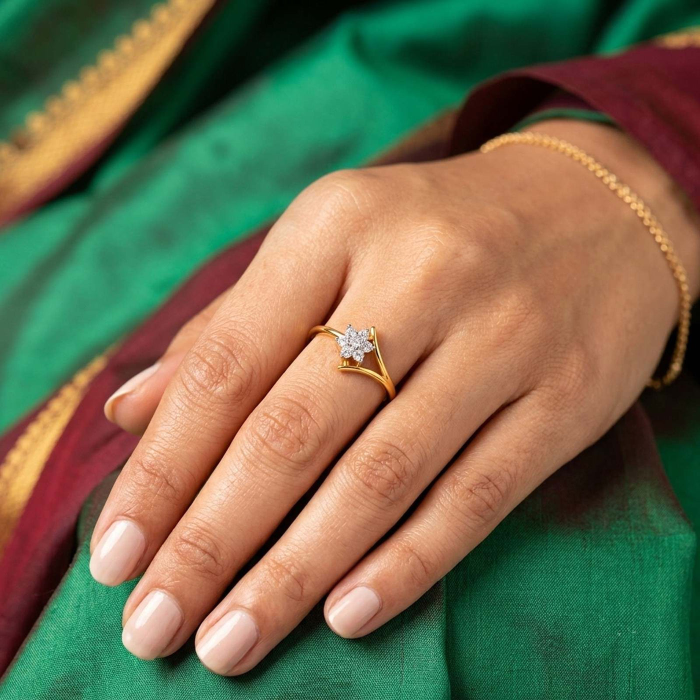 Gold ring with a cluster diamond on a person's finger