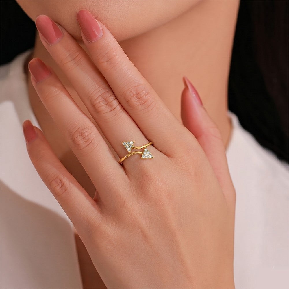 Close-up shot of a gold ring with triangular diamond accents ring.