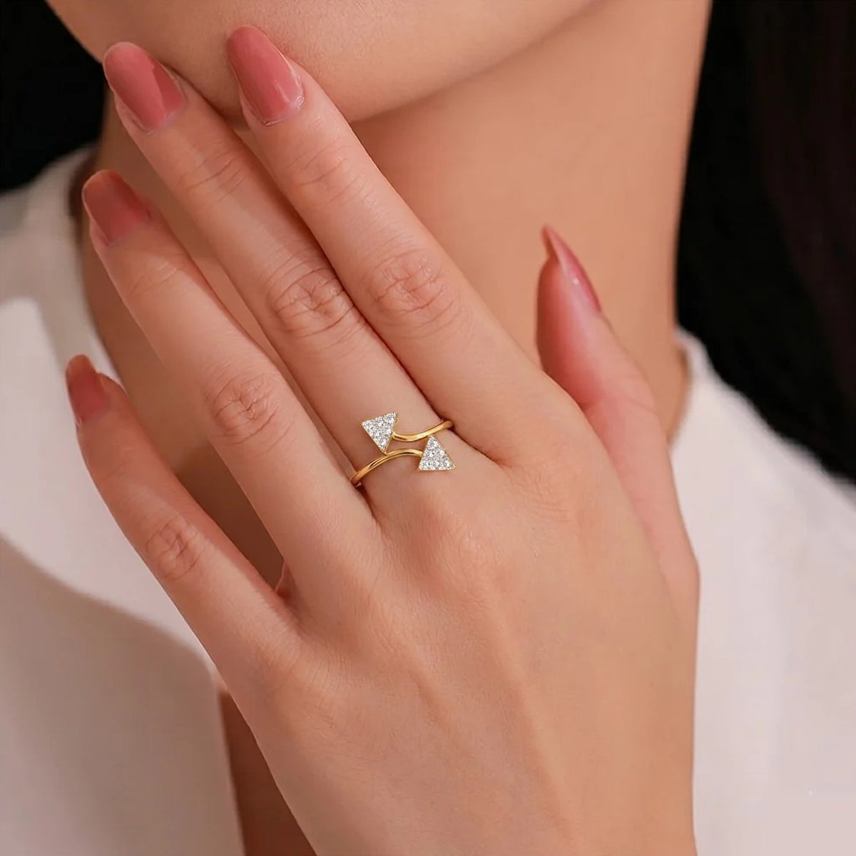 Close-up shot of a gold ring with triangular diamond accents ring.