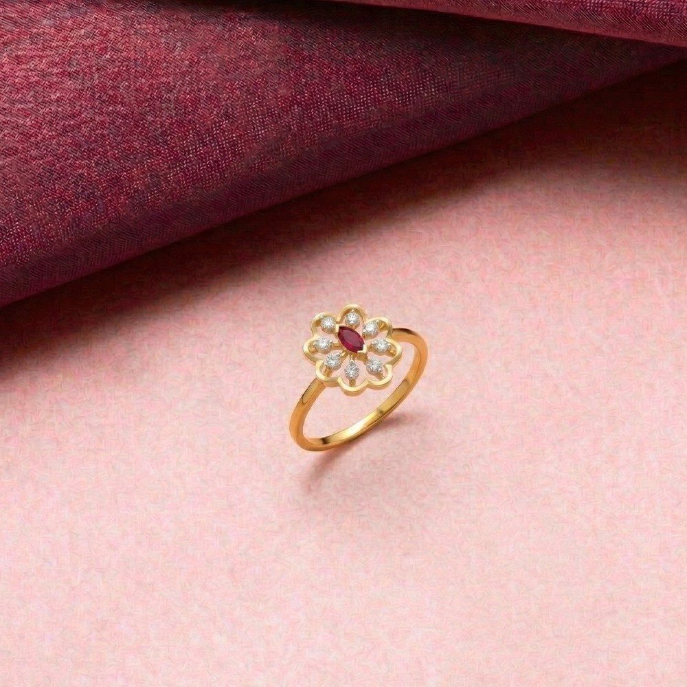 Gold and diamond with ruby gemstone setting on a pink surface.