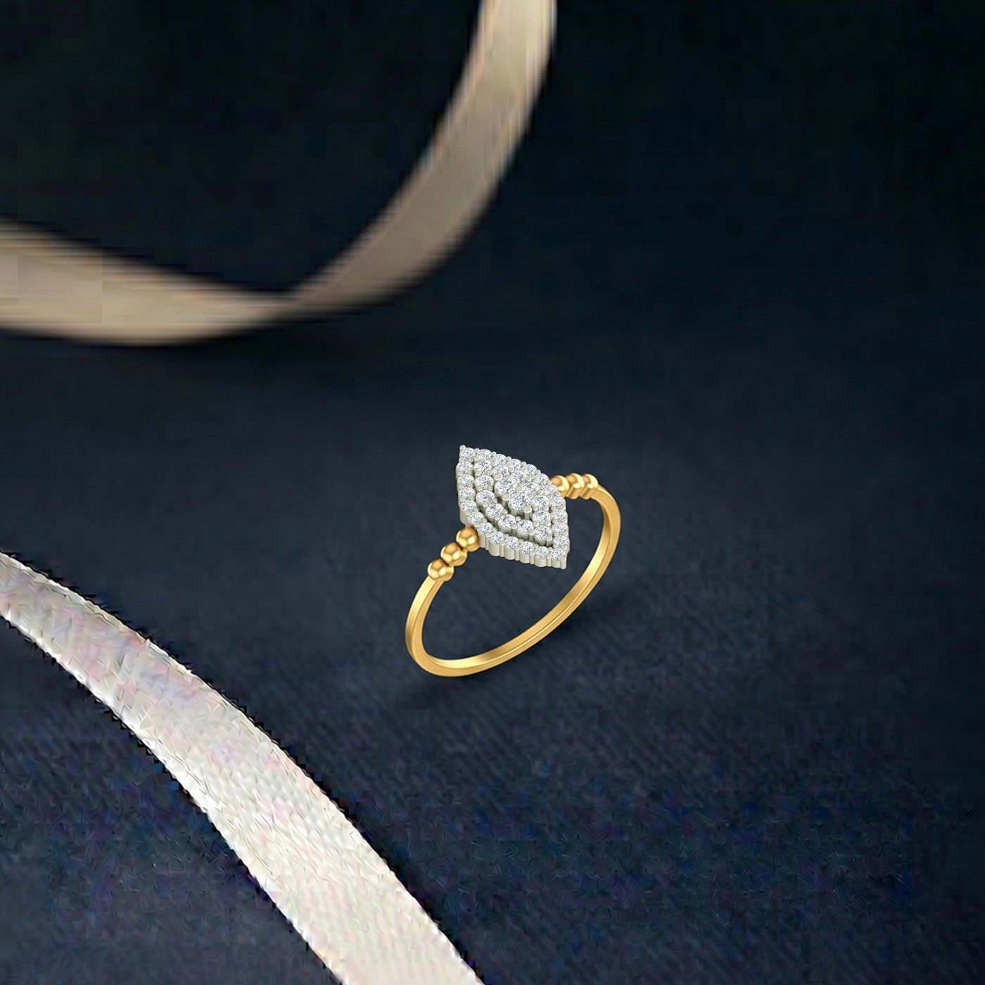 Gold and diamond with cluster setting on a blue surface.