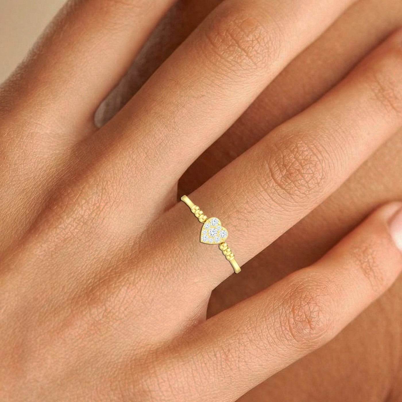 close-up shot of gold and diamond with heart-shaped cluster setting ring.
