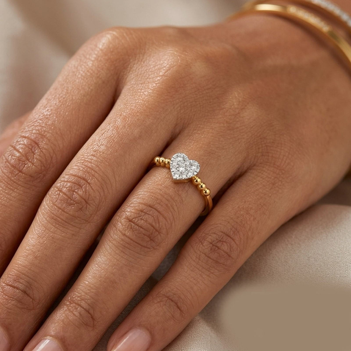 close-up shot of gold and diamond with heart-shaped cluster setting ring.