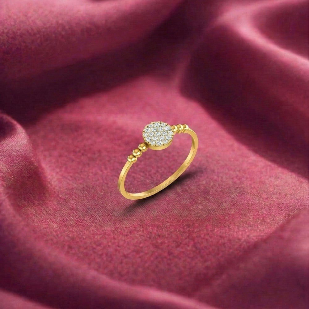Gold ring with a diamond on a red fabric background