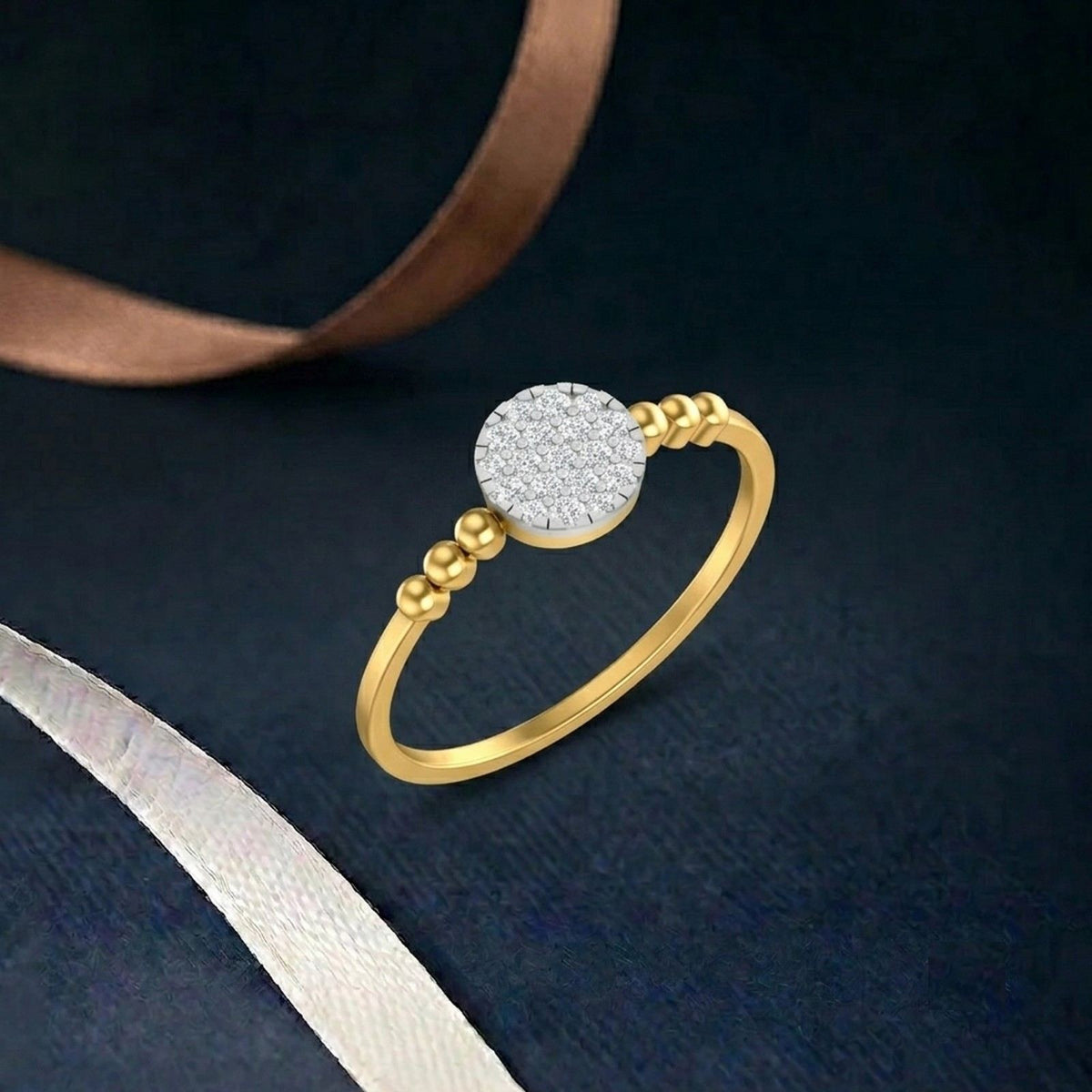 Gold ring with a diamond on a teal fabric background