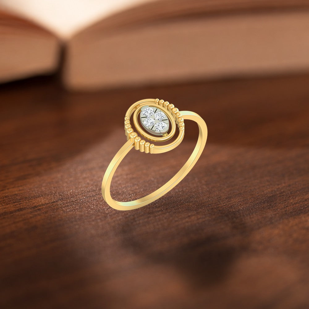 Gold and diamond with oval cluster setting on a wooden surface.