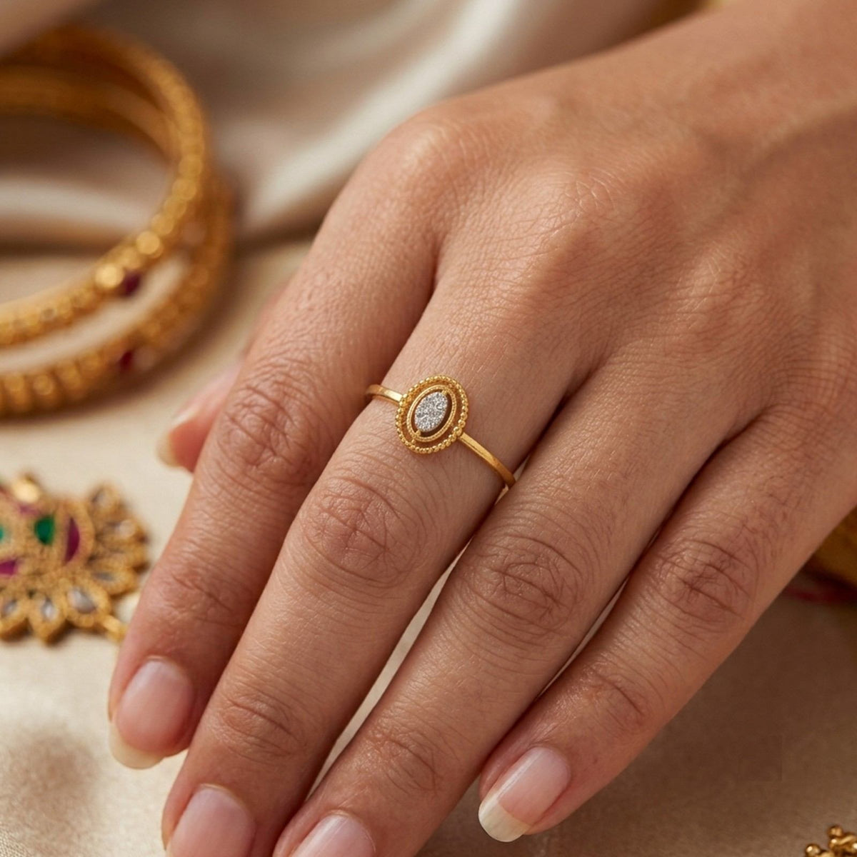 Close-up shot of a gold and diamond with oval cluster setting ring.