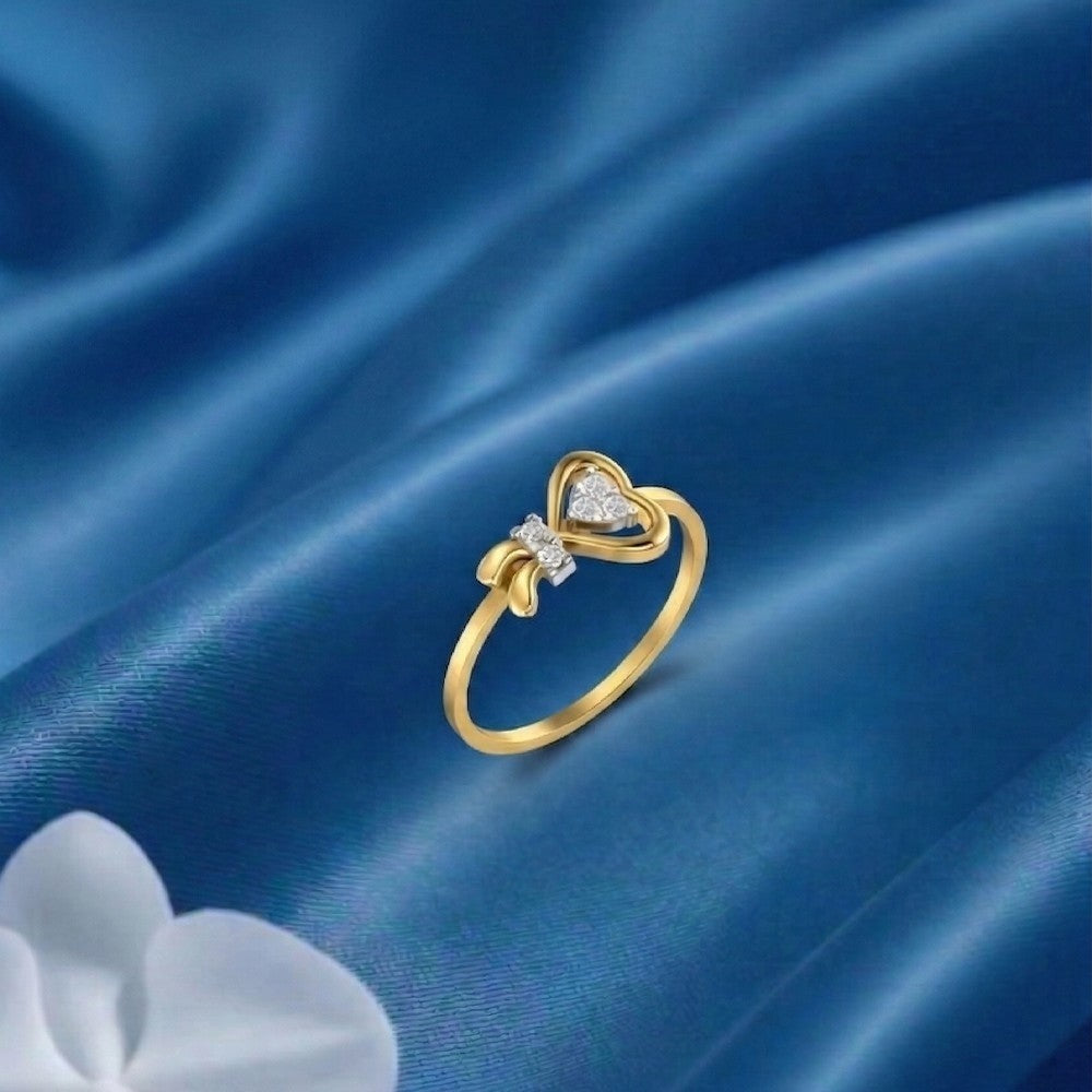 Gold and diamond with heart-shaped cluster setting on a blue fabric surface.