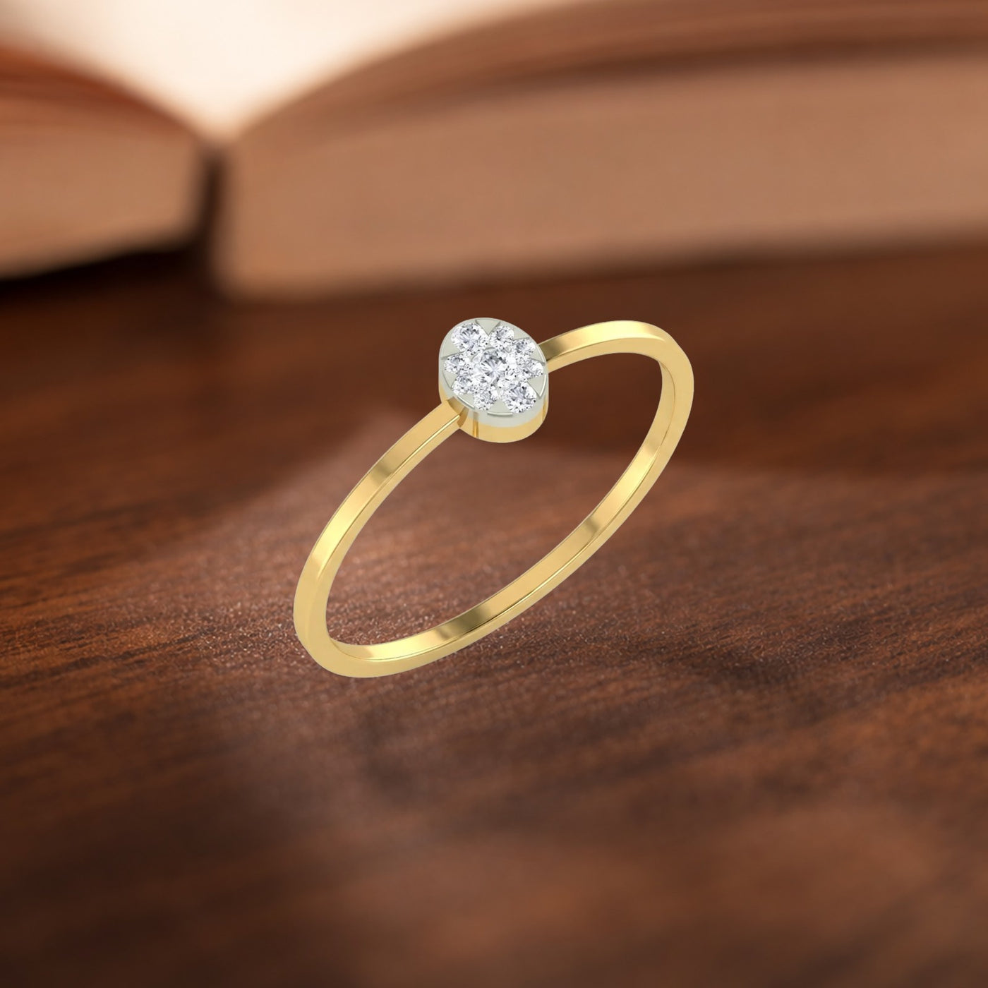 Gold and diamond with round-shaped cluster setting on a wooden surface.