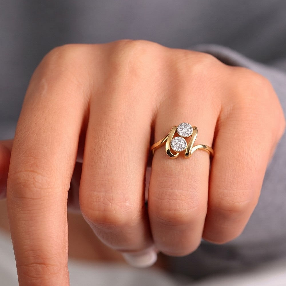 Close-up shot of  a gold and diamond with cluster setting ring.