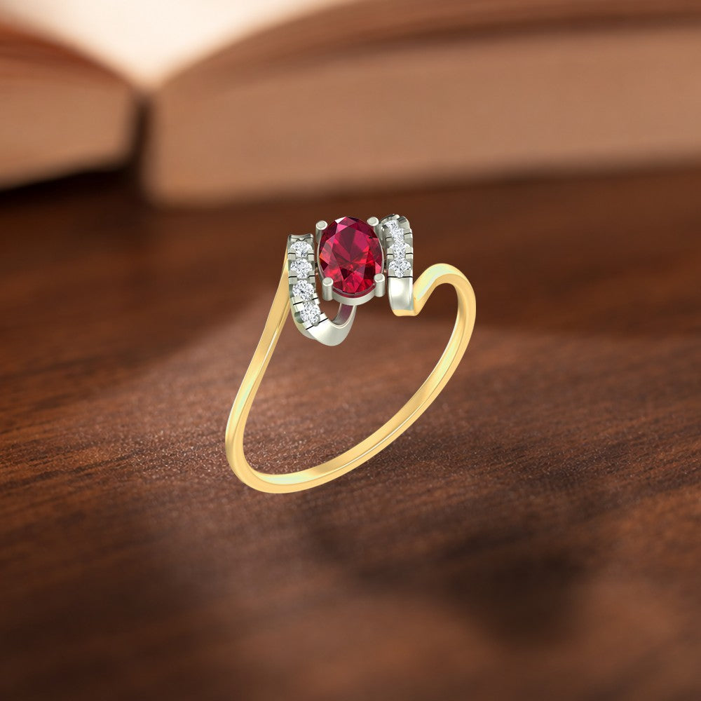 Gold and diamond with oval ruby gemstone setting on a wooden surface.