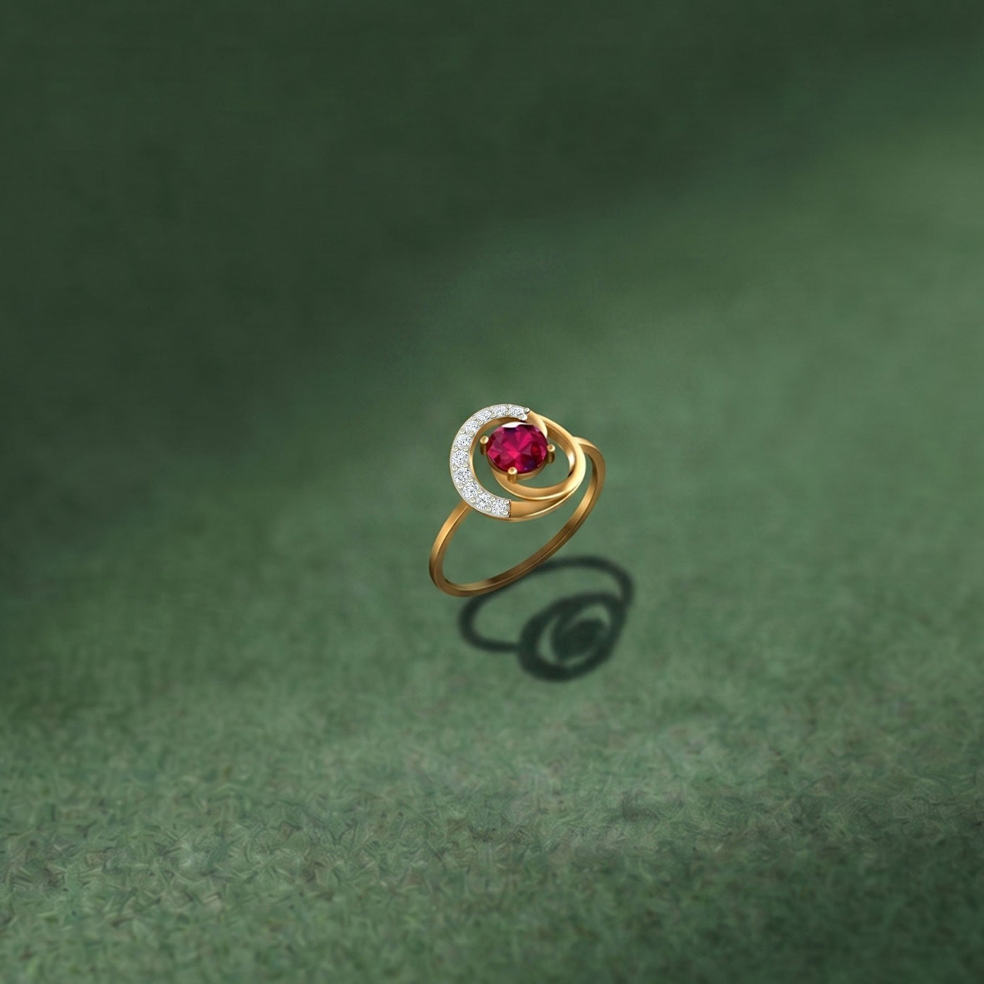Gold and diamond with ruby gemstone on a green surface.