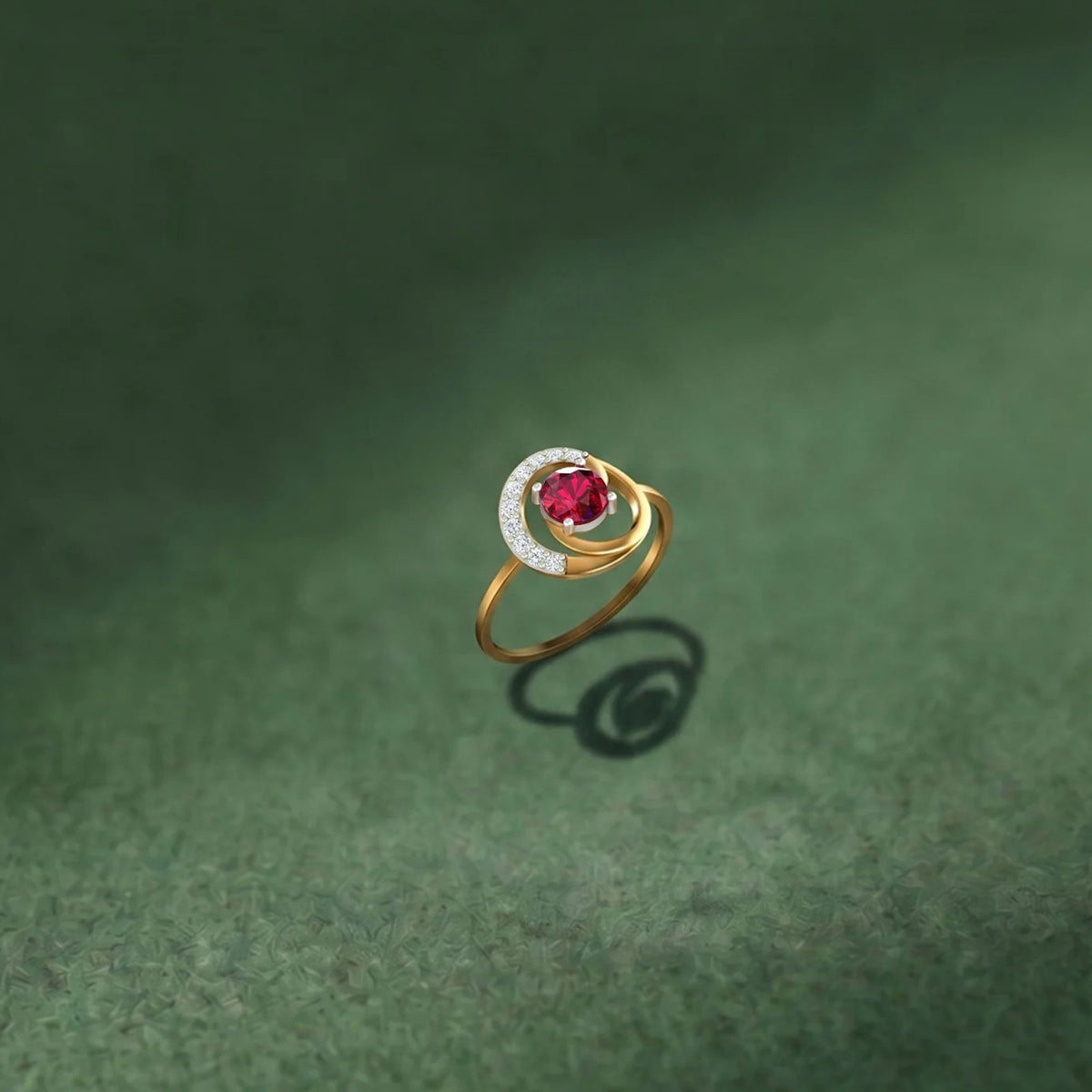 Gold and diamond with ruby gemstone on a green surface.