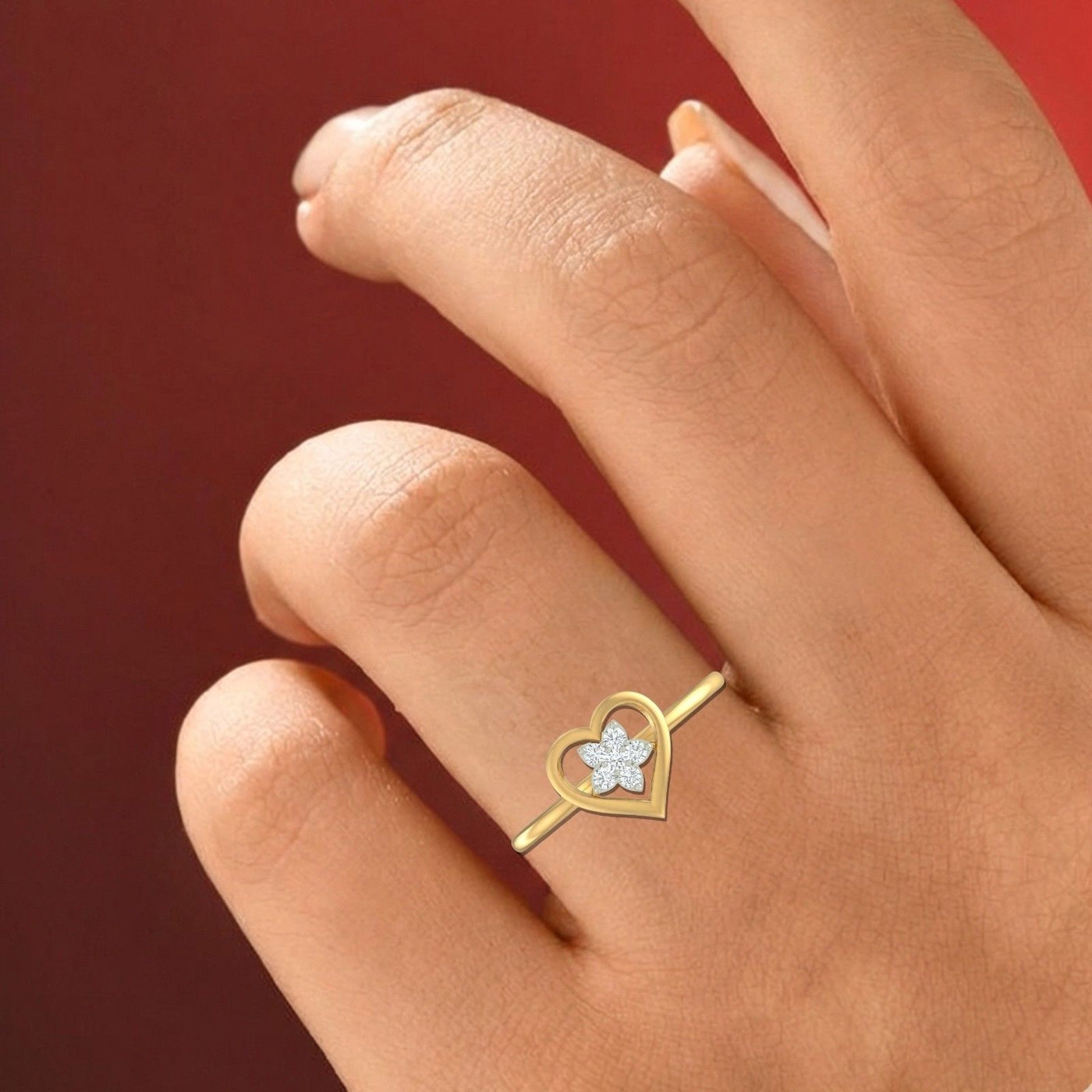 Close-up shot of a gold and diamond with heart-shaped and floral cluster setting ring.