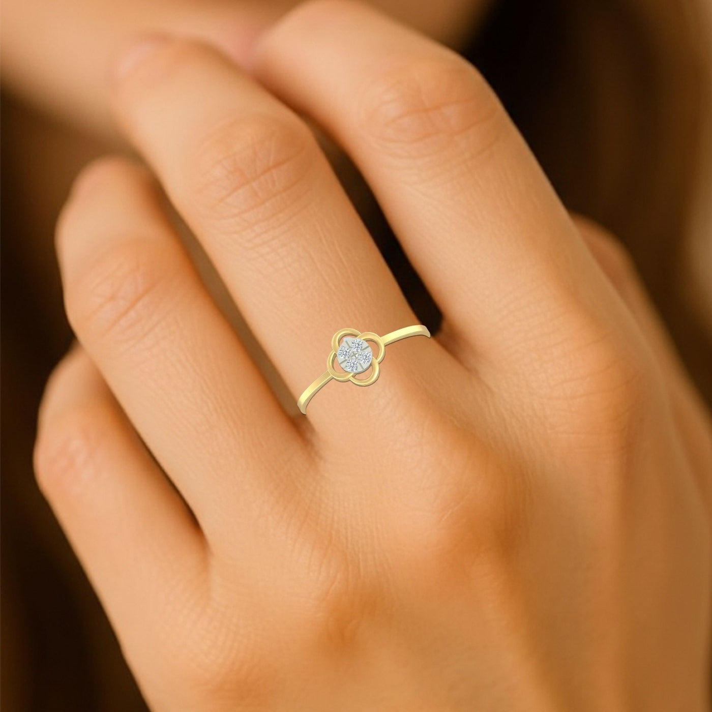 Close-up shot of a gold and diamond with floral-design and cluster setting ring.