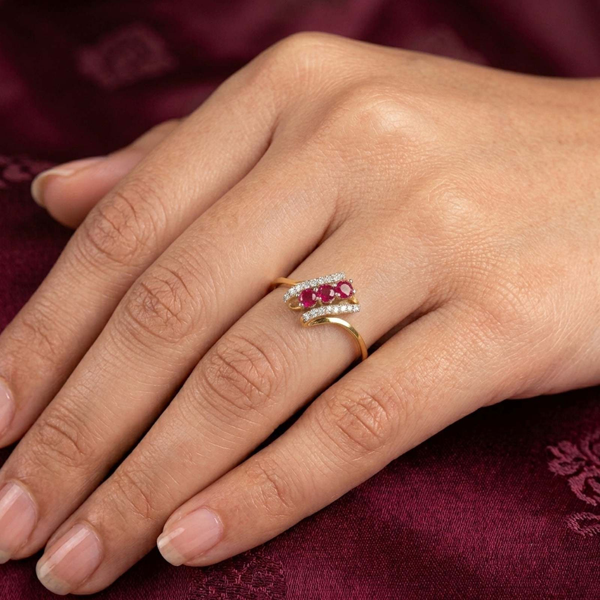Close-up shot of a gold and diamond with ruby gemstone ring