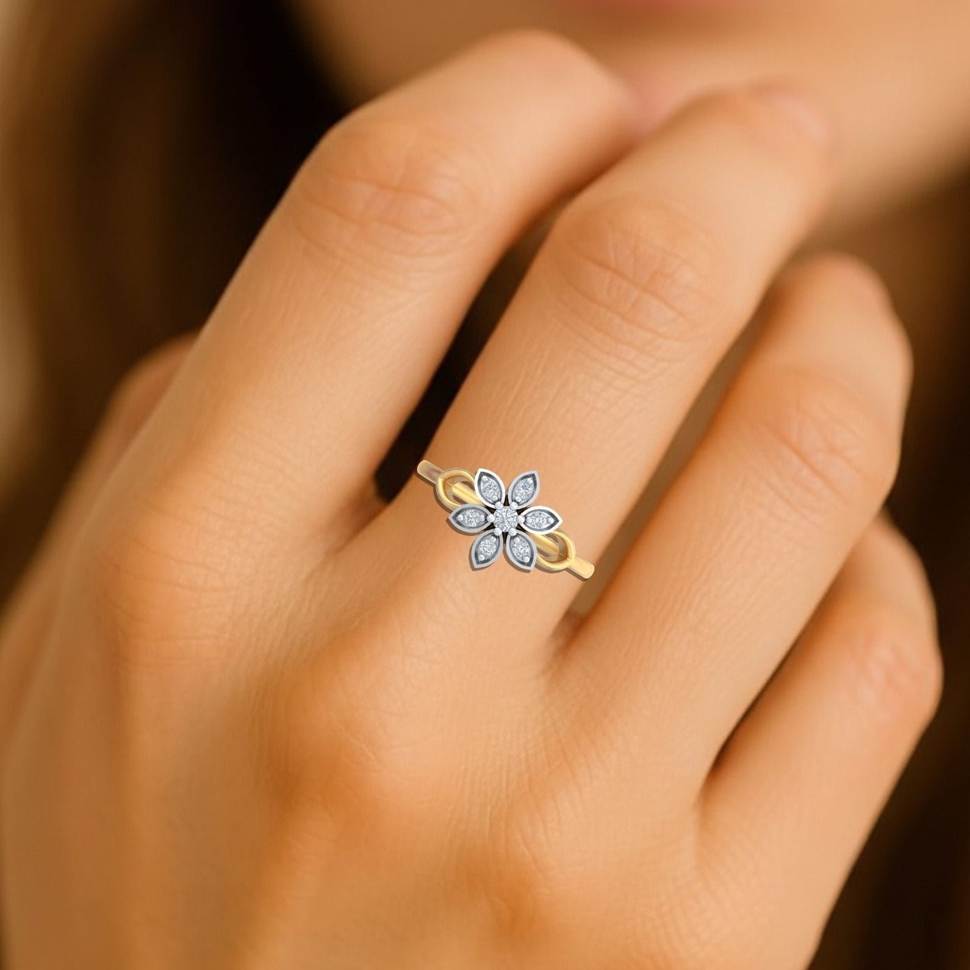 Close-up shot of a gold and diamond with floral-design ring.